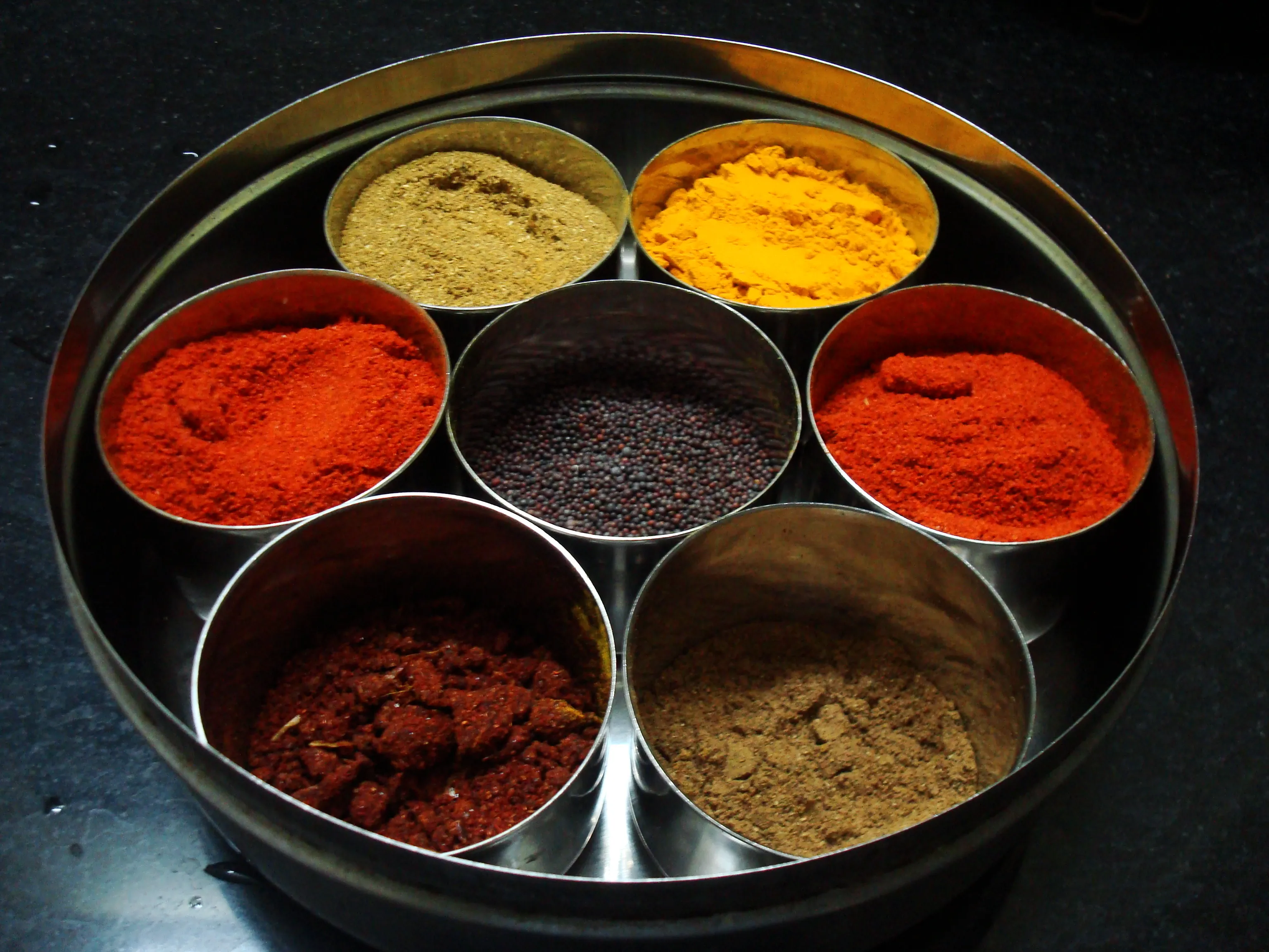 Warm Indian kitchen scene with cooking oil and traditional cookware